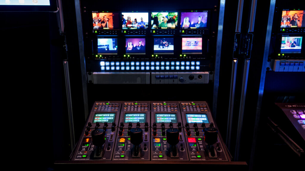 Broadcast control rack with multiview monitors and video switchers for REMI live stream setup