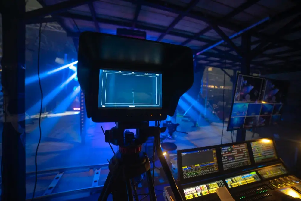 Professional Video Production Studio Setup with Live Monitoring Behind-the-scenes view of a professional video production setup with cameras, monitors, and lighting in a studio environment.