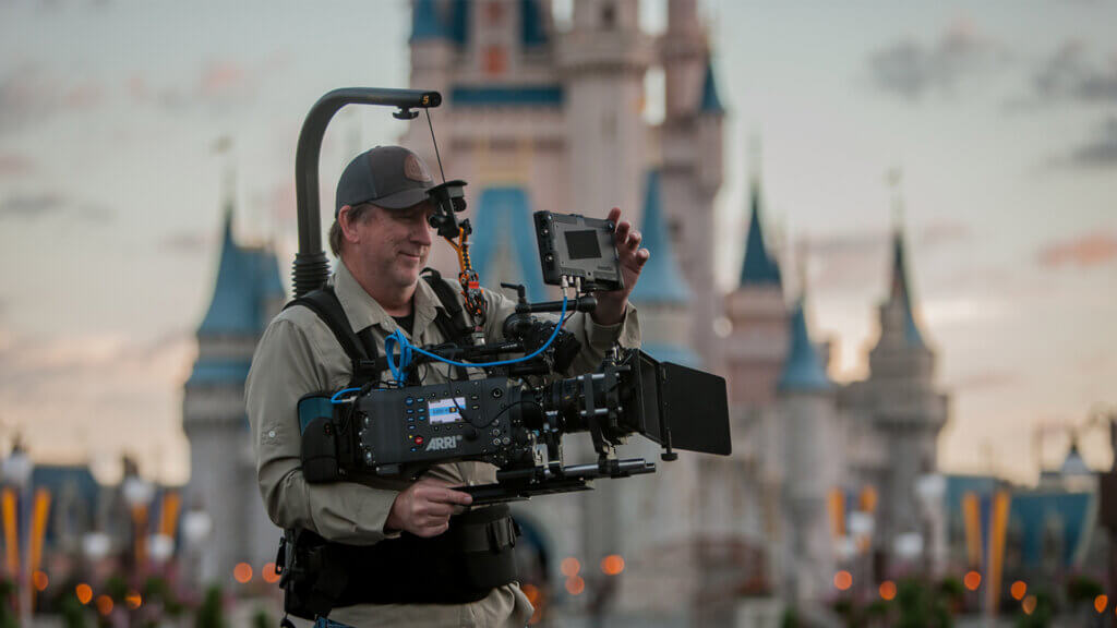 Cinematographer using steadicam to film branded content at outdoor location