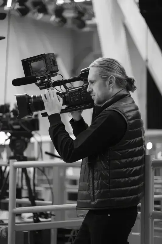 Professional cameraman filming in a studio with high-end video equipment